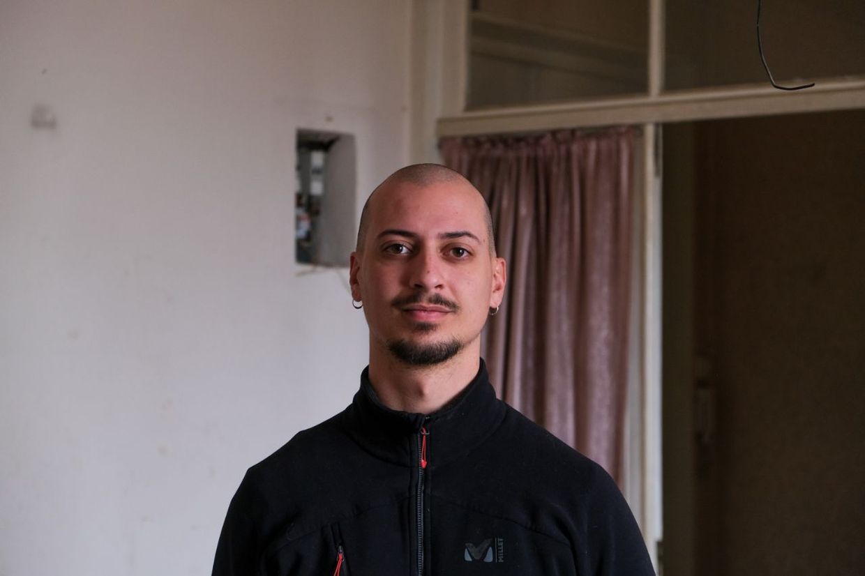 Protesters outside the courthouse hold a sign reading